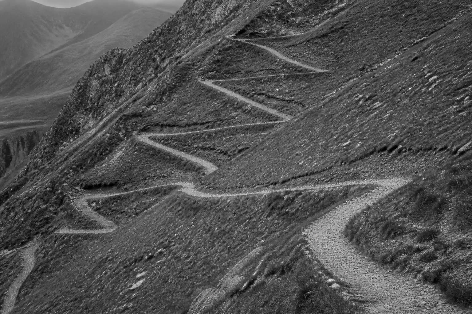 Black-and-white mountain switchback trail repeating up a slope